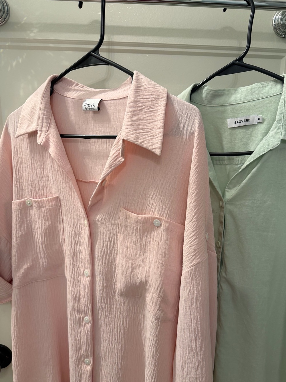 Two quarter length sleeve blouses. One pink and one green. Can be long sleeve to